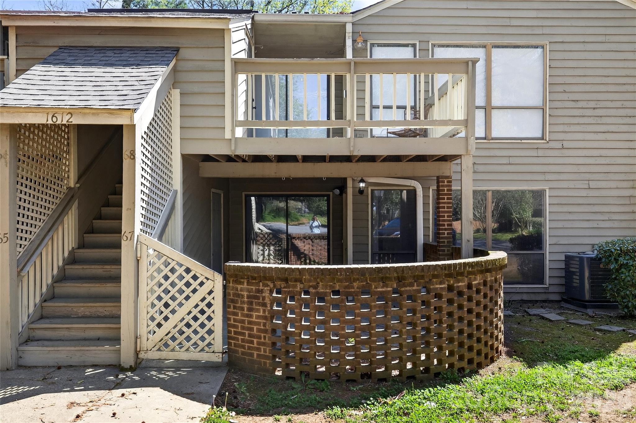 1612 Sharon Road West, Unit 67 Charlotte, NC 28210 - Photo 9 of 19 a side view of a house with wooden fence
