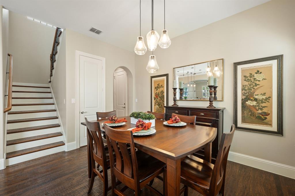 738 East Main Street Coppell, TX 75019 - Photo 11 of 27 a view of a dining room with furniture wooden floor and chandelier