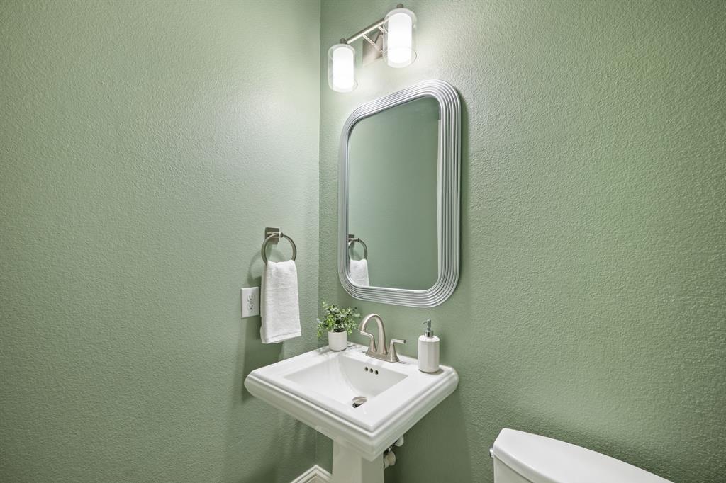 738 East Main Street Coppell, TX 75019 - Photo 12 of 27 a bathroom with a sink and a mirror