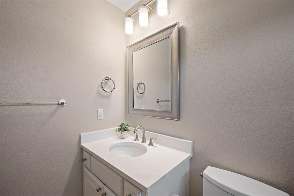 738 East Main Street Coppell, TX 75019 - Photo 18 of 27 a bathroom with a sink toilet and mirror