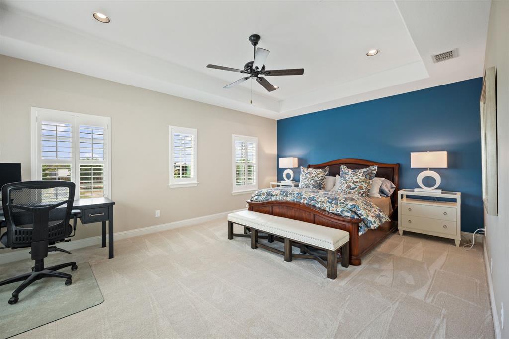 738 East Main Street Coppell, TX 75019 - Photo 21 of 27 a bedroom with a bed and a chandelier