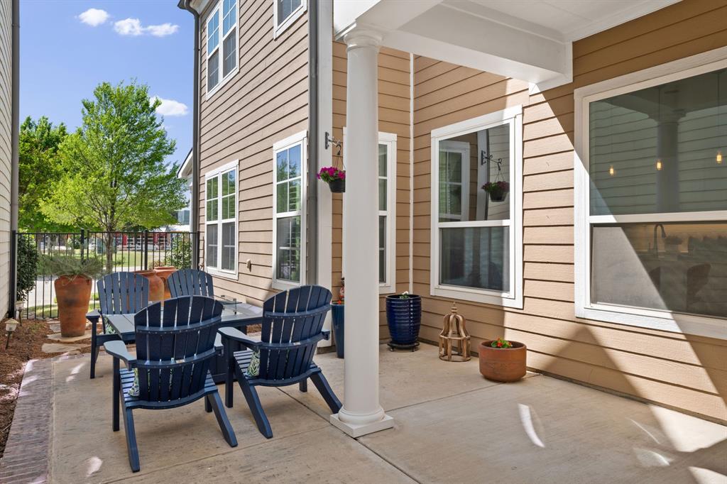 738 East Main Street Coppell, TX 75019 - Photo 24 of 27 a view of a patio with table and chairs and wooden fence