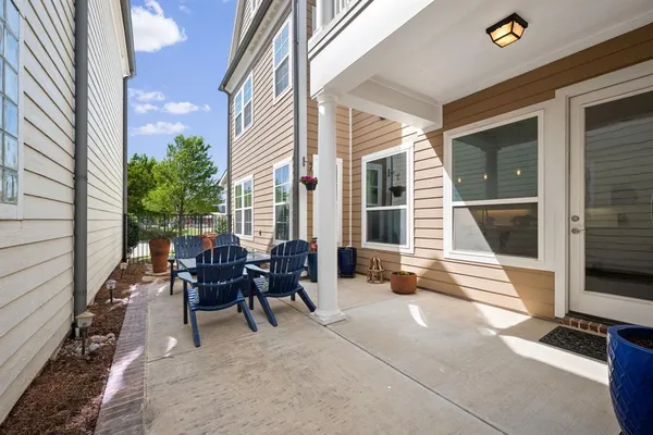 a view of a patio with table and chairs and wooden floor