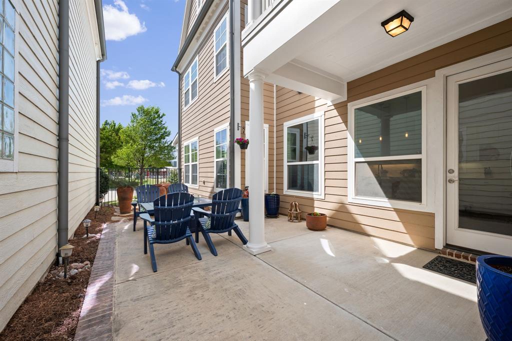 738 East Main Street Coppell, TX 75019 - Photo 26 of 27 a view of a patio with table and chairs and wooden floor