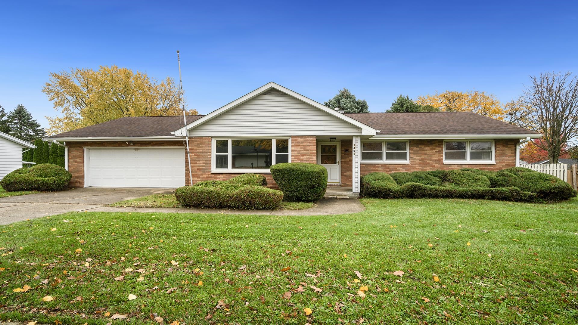 1405 Crest Lane Rochelle, IL 61068 - Photo 1 of 30 a front view of a house with a yard and garage