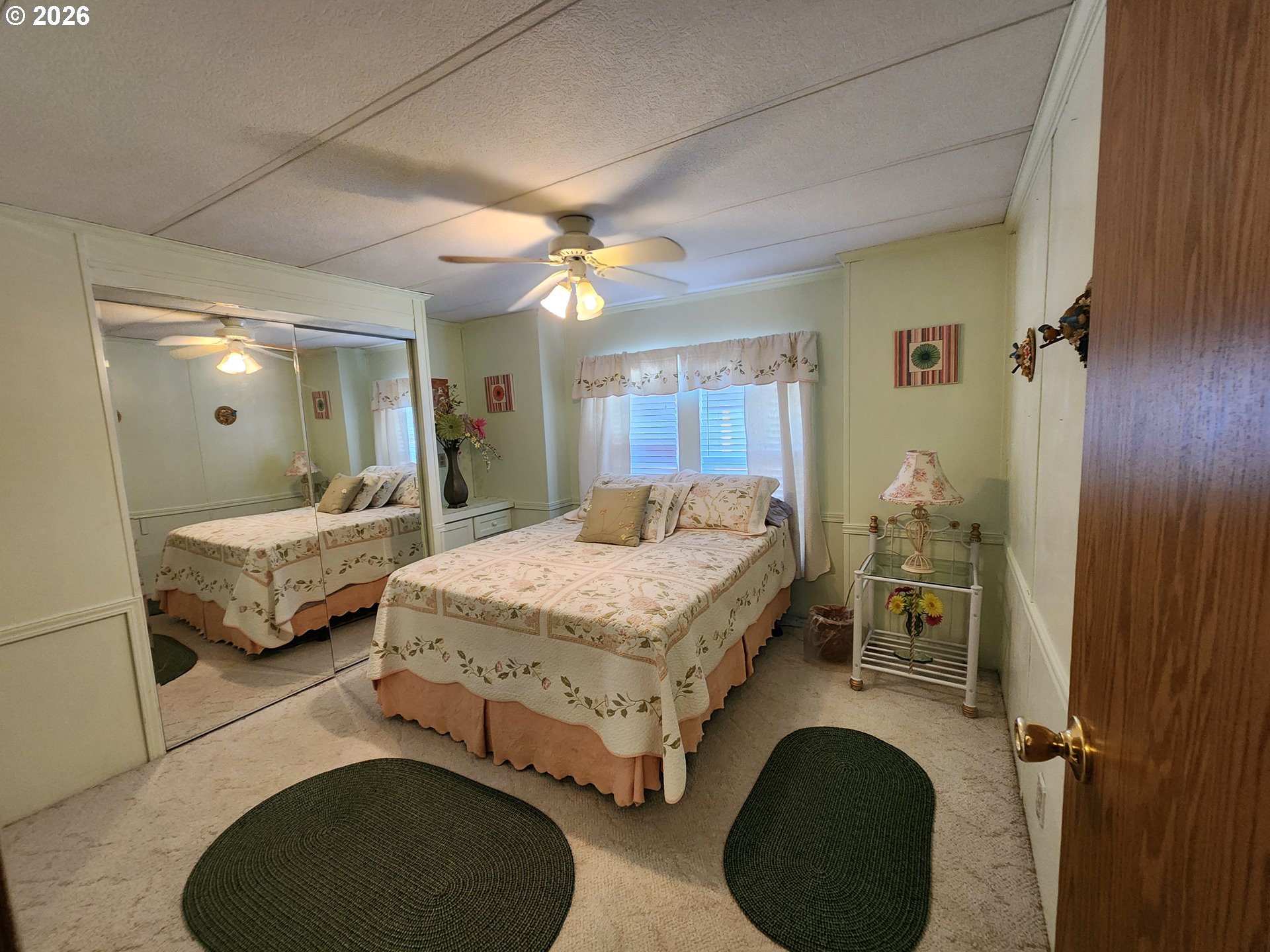 5422 Portland Road Northeast Salem, OR 97305 - Photo 13 of 14 a bedroom with a bed and a mirror
