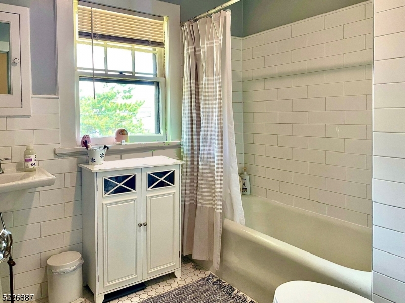 19 Valley Road Montclair, NJ 07042 - Photo 14 of 22 a bathroom with a sink a toilet and bathtub