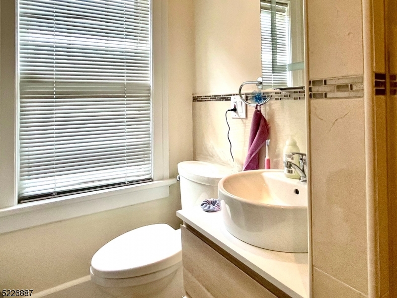 19 Valley Road Montclair, NJ 07042 - Photo 17 of 22 a white toilet sitting next to a bathroom sink and tub