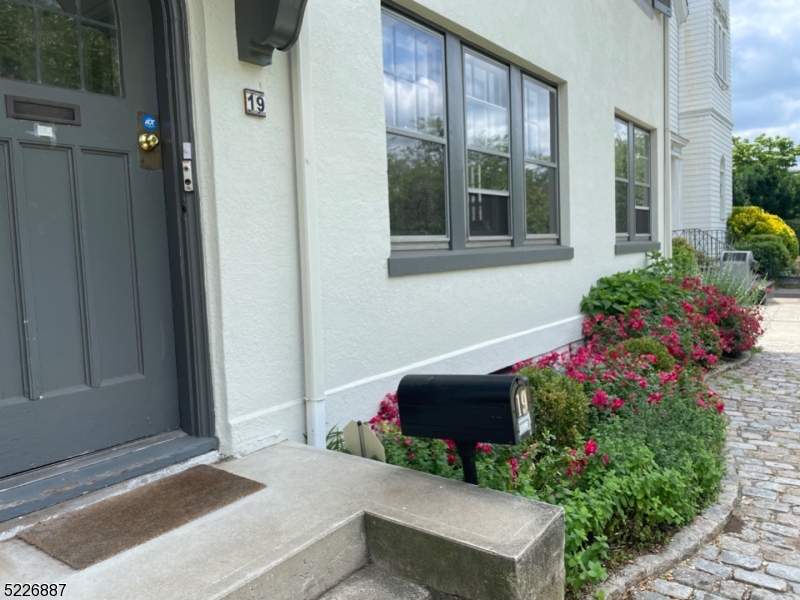 19 Valley Road Montclair, NJ 07042 - Photo 22 of 22 a front view of a house with a yard and flowers