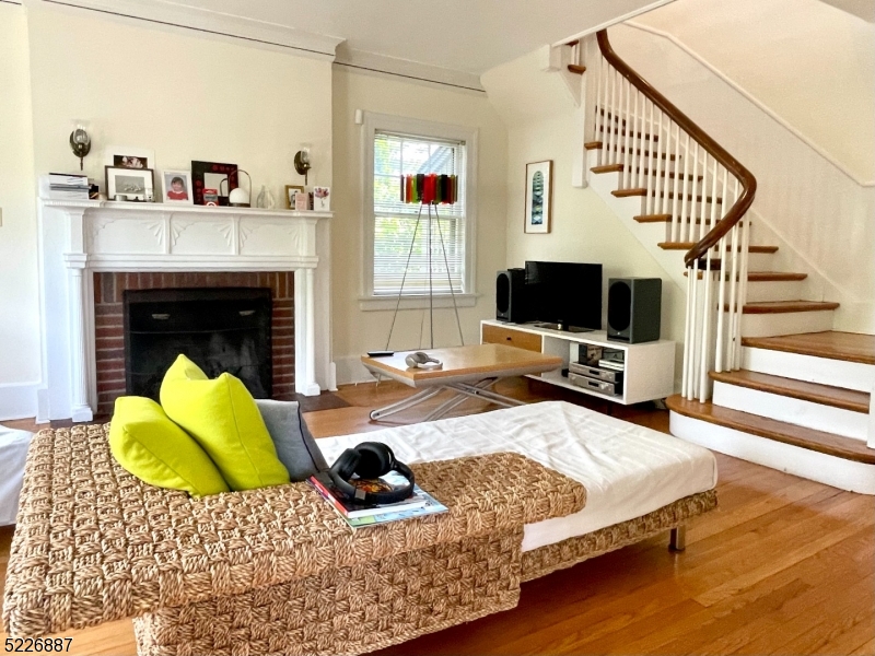 19 Valley Road Montclair, NJ 07042 - Photo 3 of 22 a living room with a couch and a flat screen tv