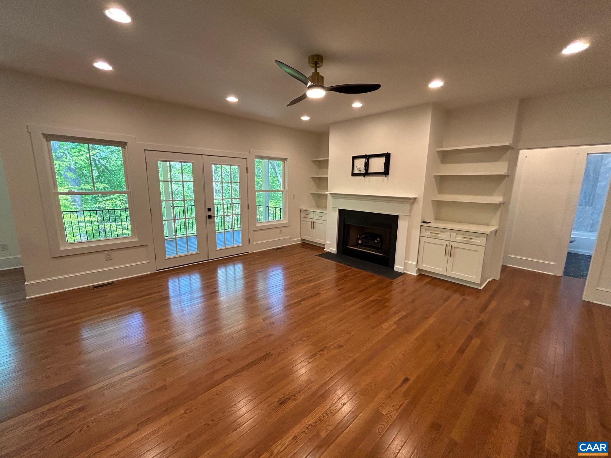 329 Carrsbrook Drive Charlottesville, VA 22901 - Photo 44 of 75 an empty room with wooden floor fireplace and windows