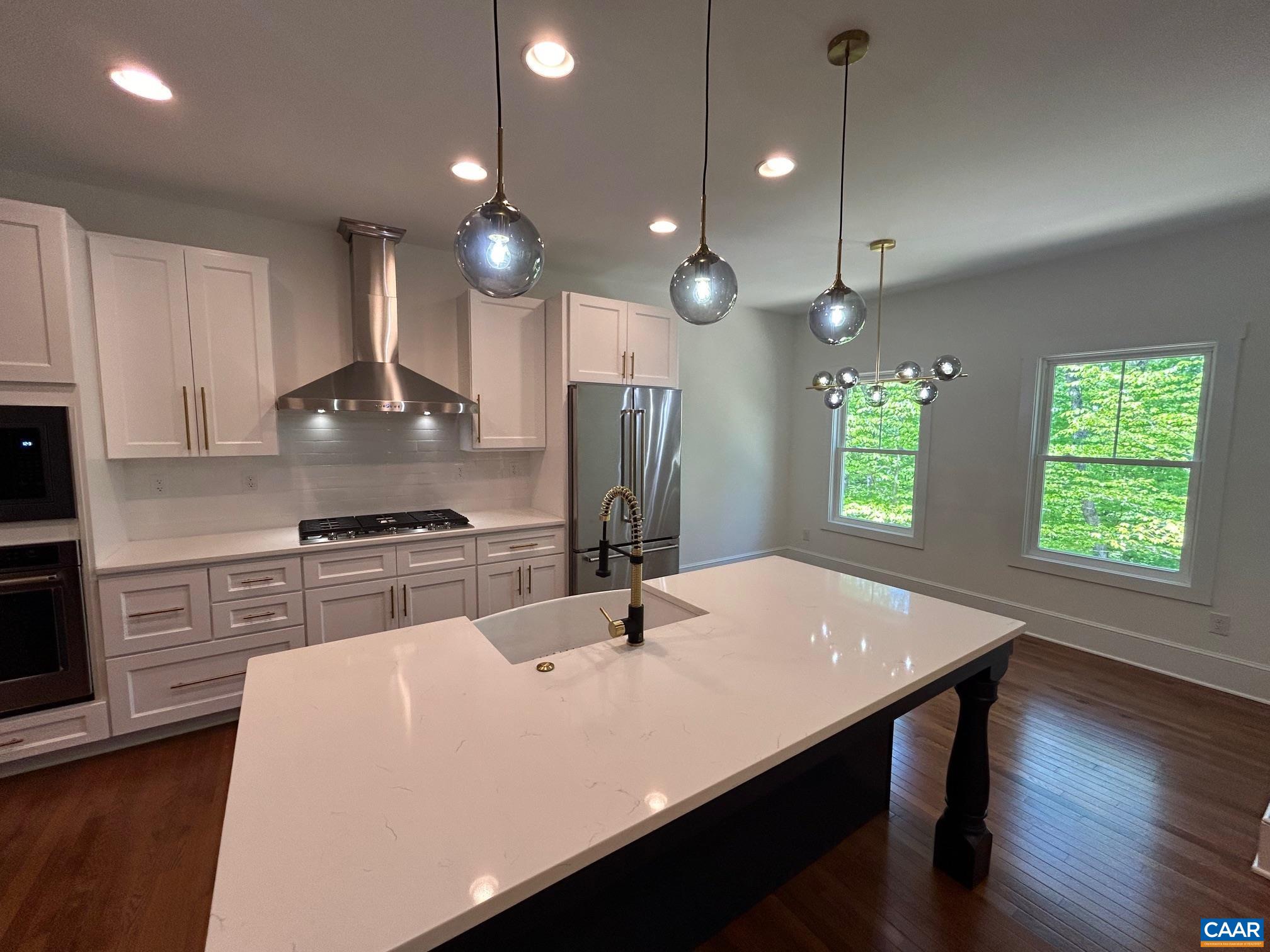 329 Carrsbrook Drive Charlottesville, VA 22901 - Photo 55 of 75 a kitchen with stainless steel appliances a dining table chairs stove refrigerator and cabinets