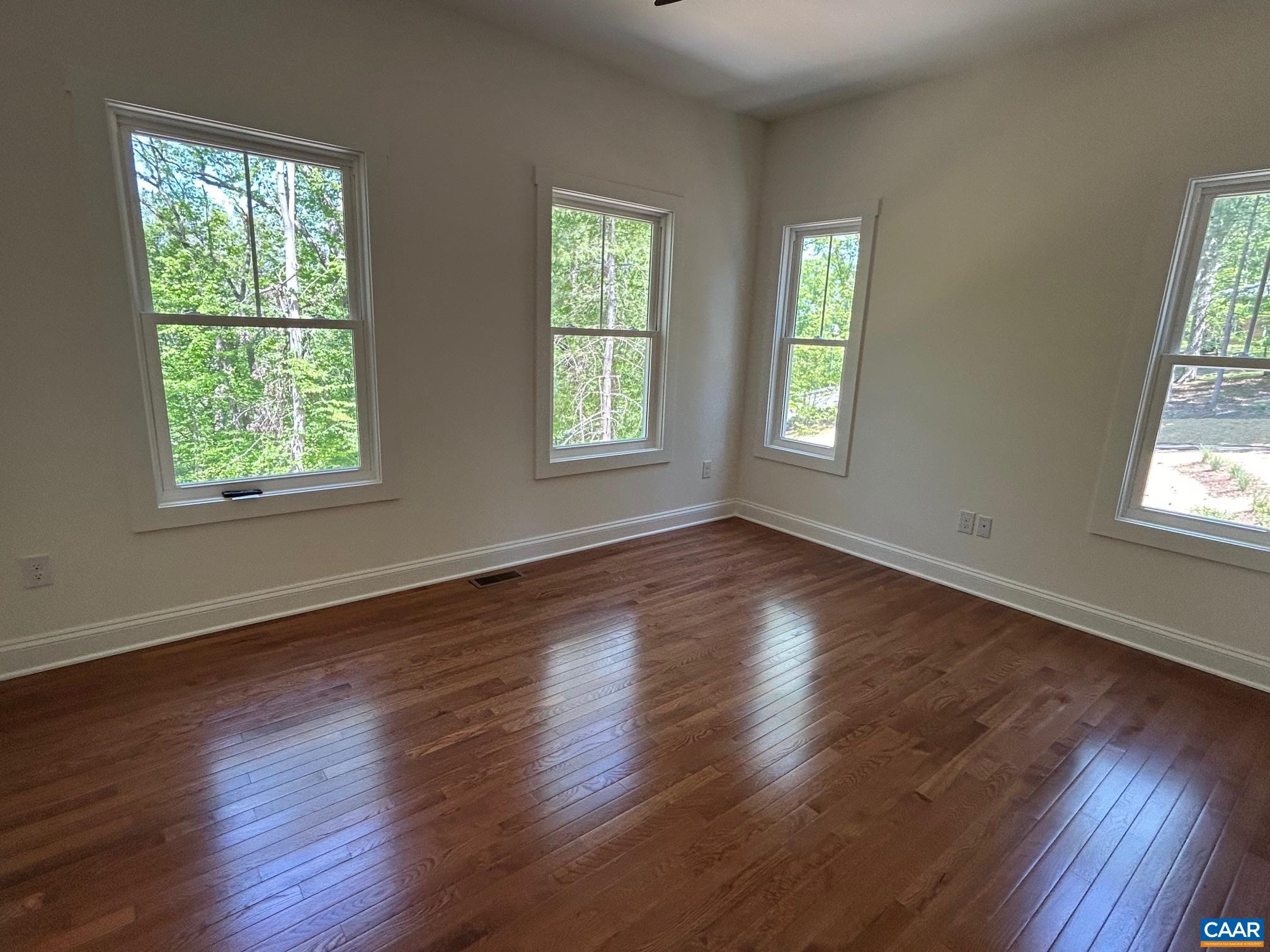 329 Carrsbrook Drive Charlottesville, VA 22901 - Photo 73 of 75 a view of an empty room with wooden floor and a window