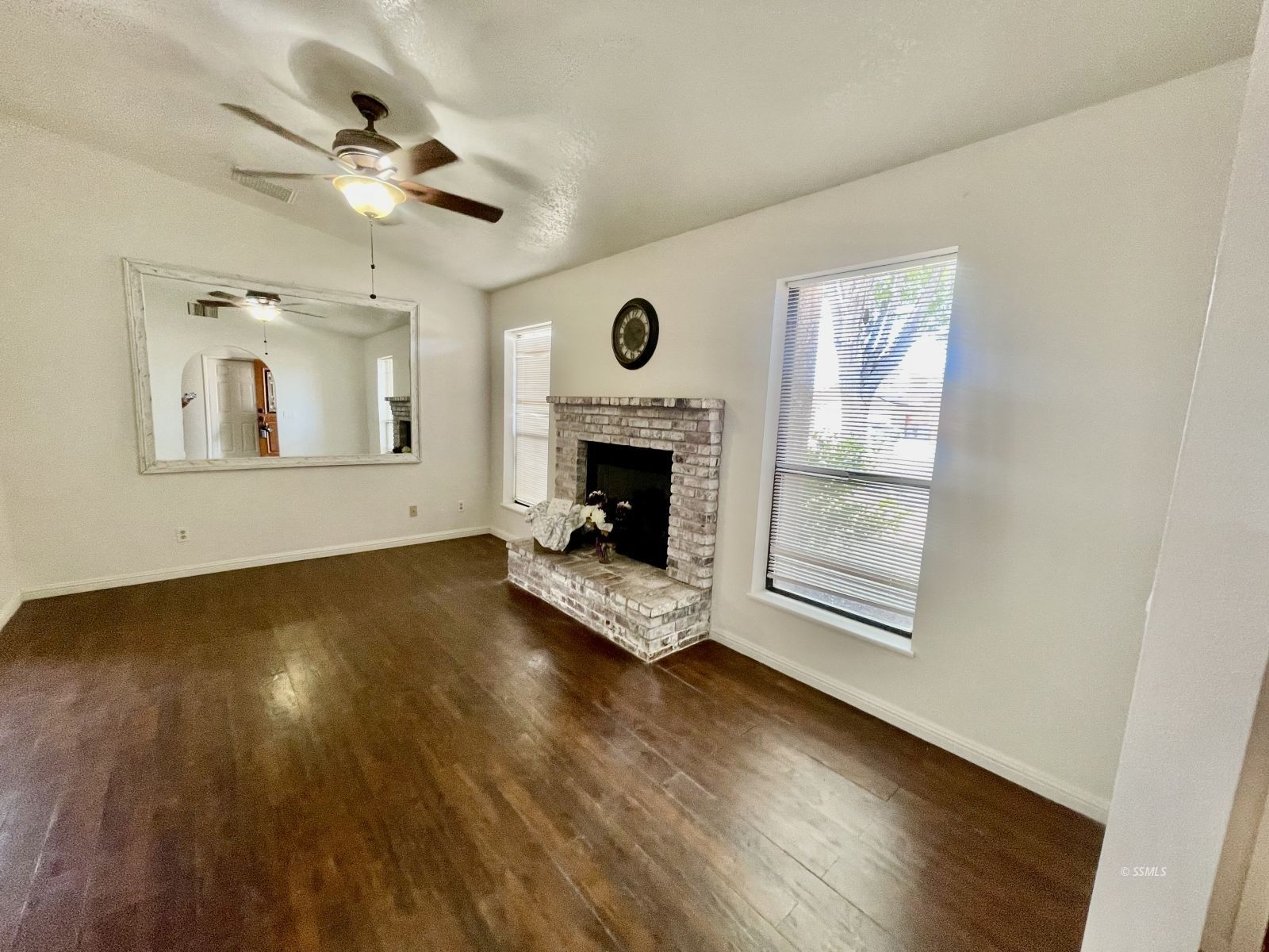 225 Michele Street Ridgecrest, CA 93555 - Photo 3 of 36 a view of an empty room with wooden floor fireplace and a window