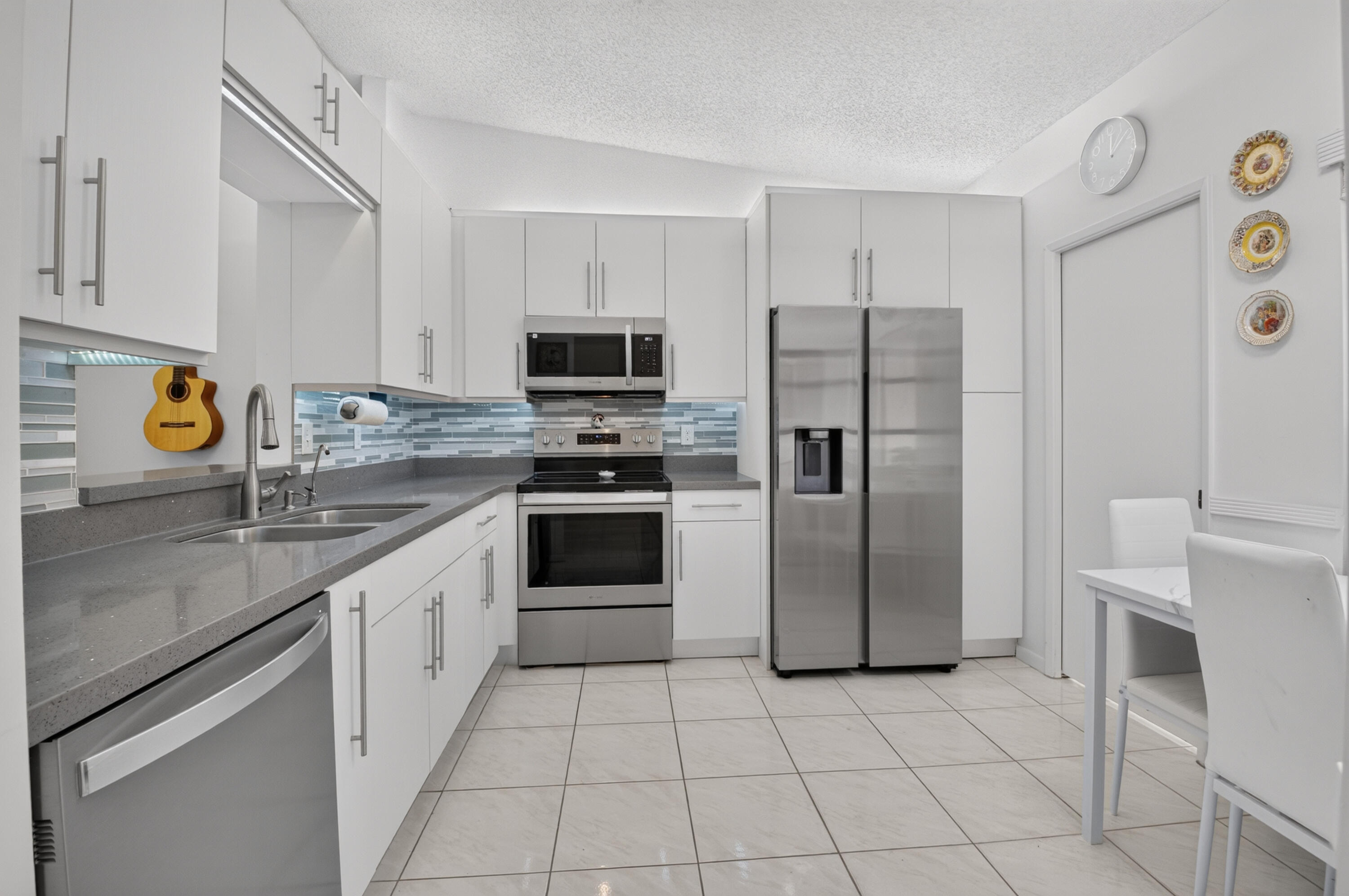 8246 Springview Terrace Boca Raton, FL 33496 - Photo 13 of 53 a kitchen with stainless steel appliances granite countertop a refrigerator sink and stove