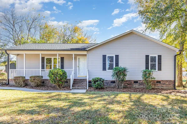 a view of a house with swimming pool in front of it
