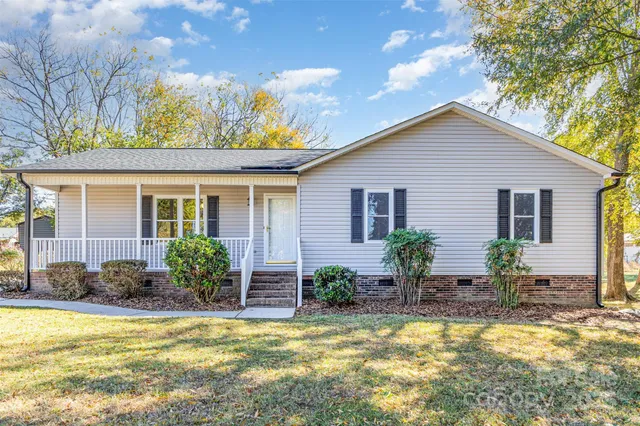 a view of a house with swimming pool in front of it