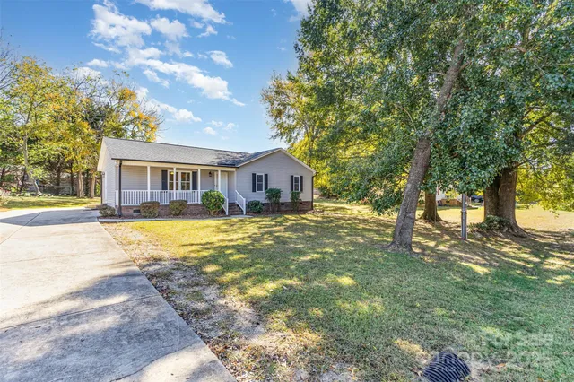 a house with swimming pool in front of it