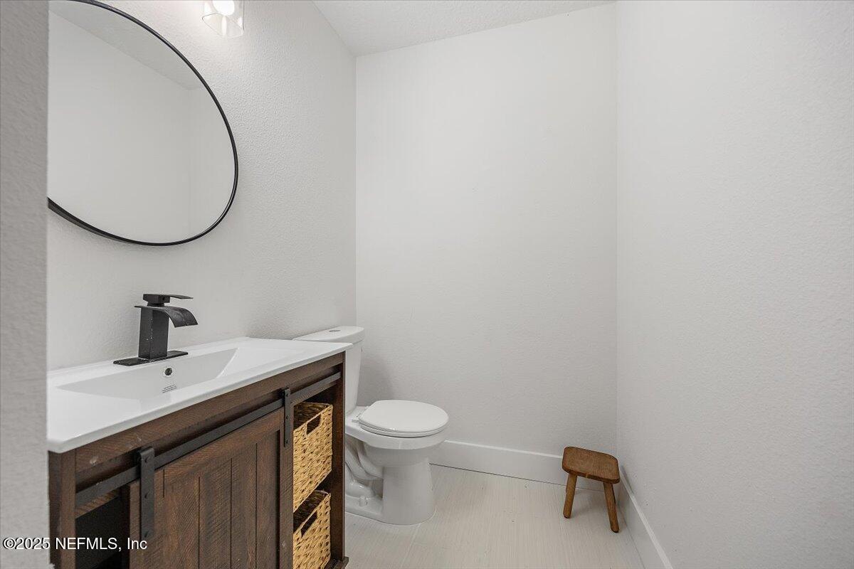 1435 Flanders Road Jacksonville, FL 32207 - Photo 14 of 21 a bathroom with a sink and a mirror