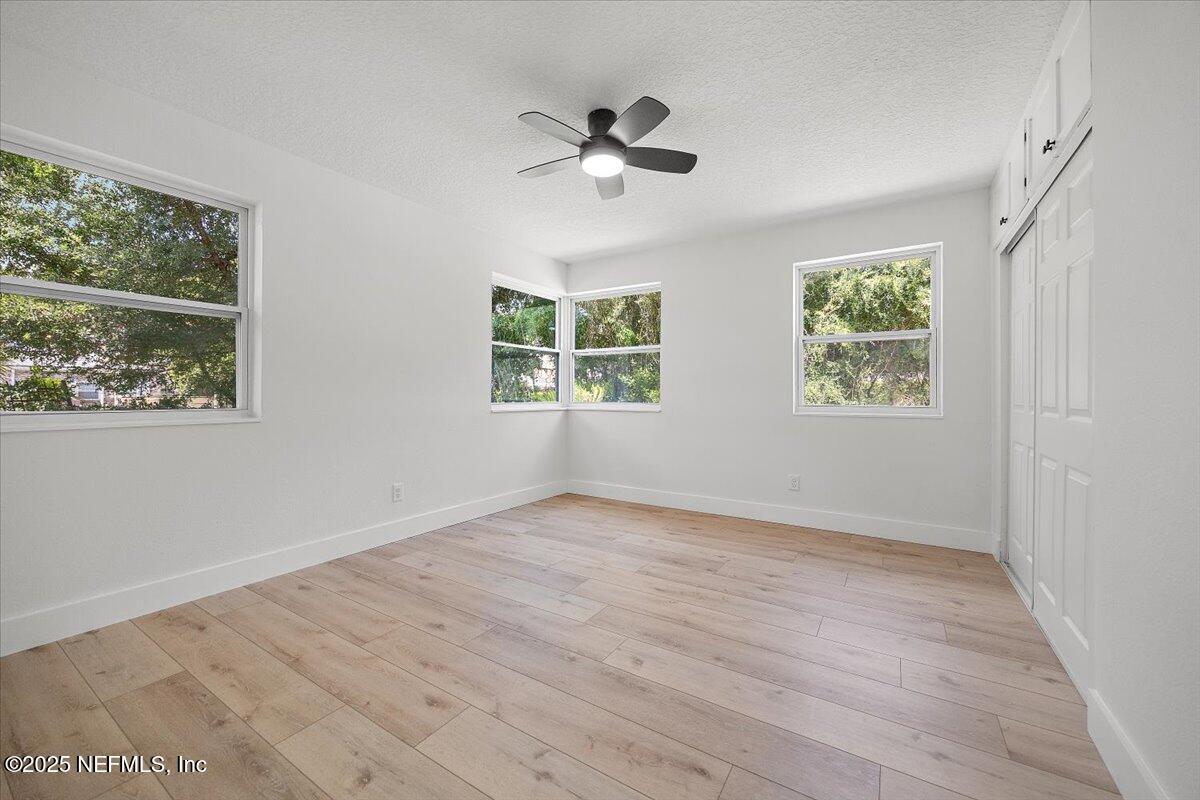 1435 Flanders Road Jacksonville, FL 32207 - Photo 15 of 21 a view of an empty room with a window and wooden floor