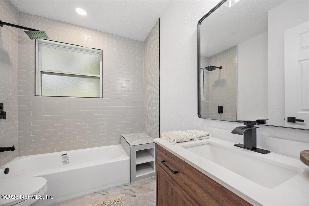 1435 Flanders Road Jacksonville, FL 32207 - Photo 16 of 21 a bathroom with a tub sink and mirror