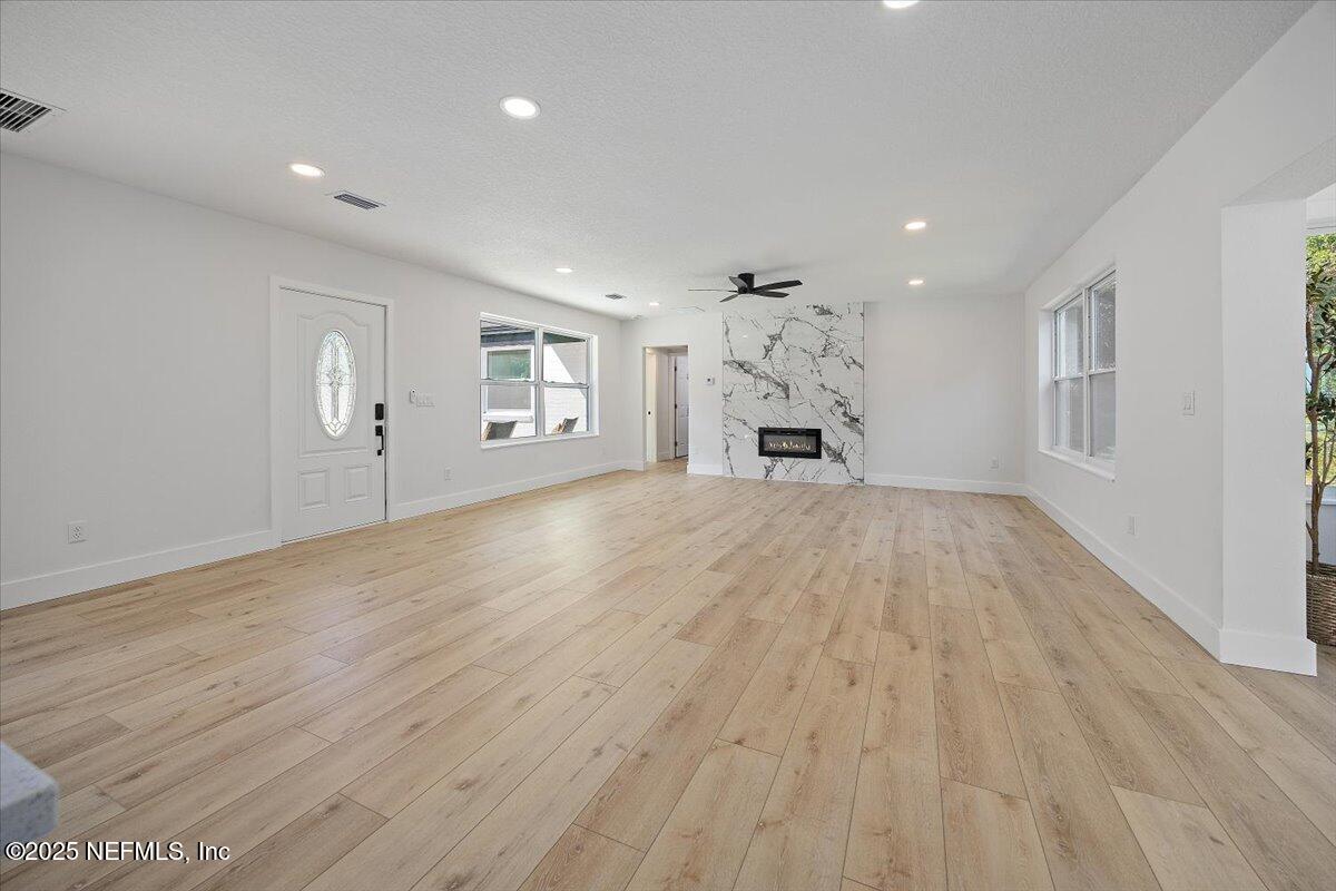 1435 Flanders Road Jacksonville, FL 32207 - Photo 3 of 21 wooden floor in an empty room with a window