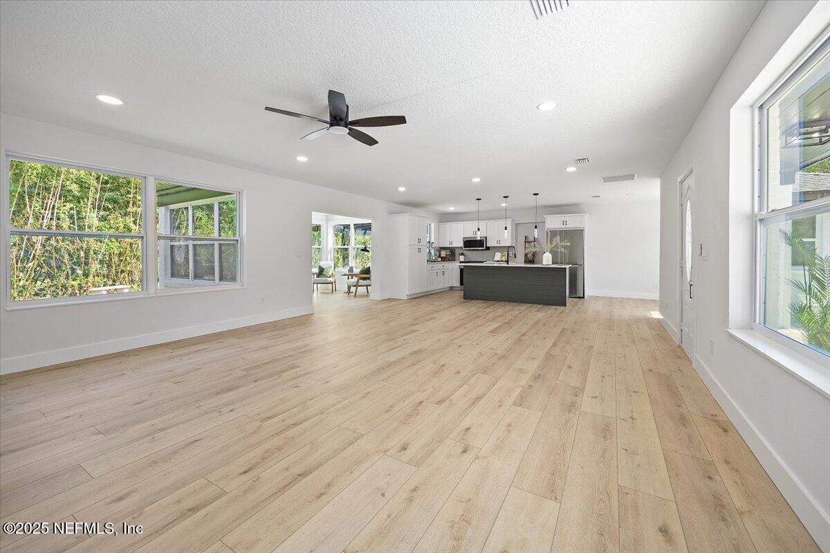 1435 Flanders Road Jacksonville, FL 32207 - Photo 4 of 21 a view of an empty room with a window and wooden floor