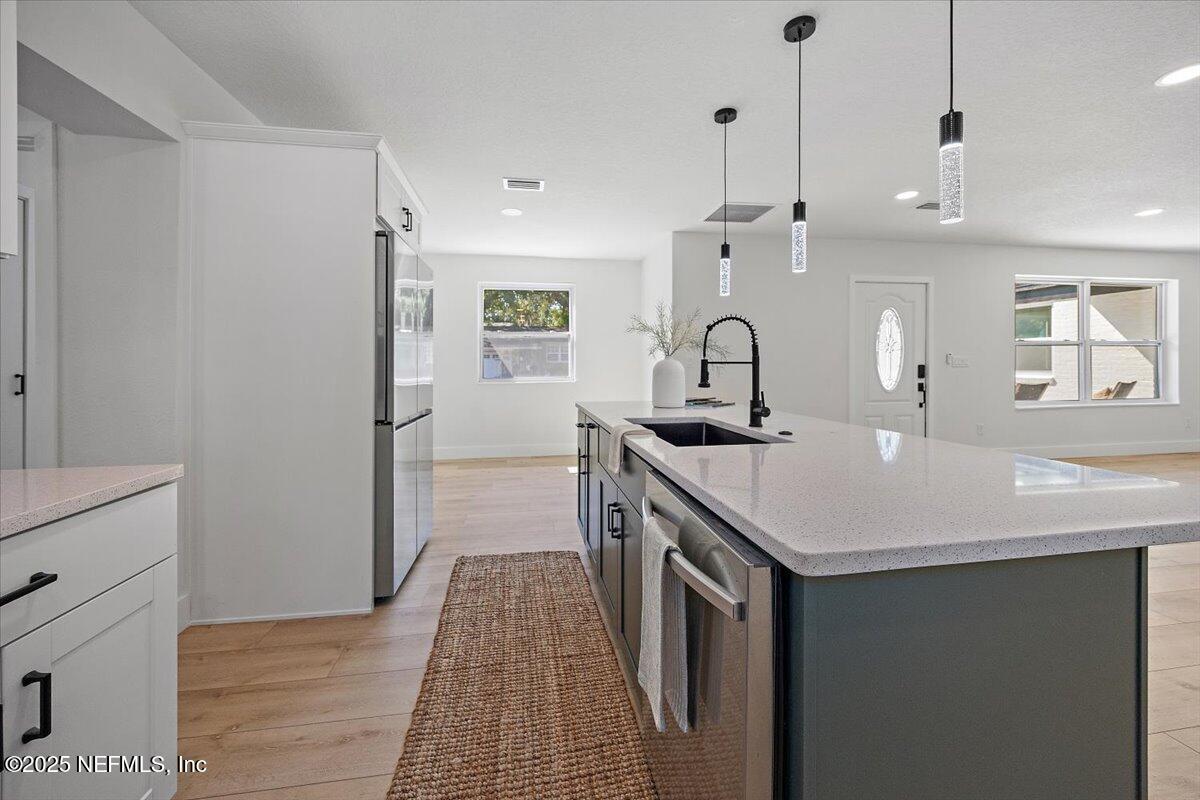 1435 Flanders Road Jacksonville, FL 32207 - Photo 6 of 21 a kitchen with a sink a counter top space and cabinets