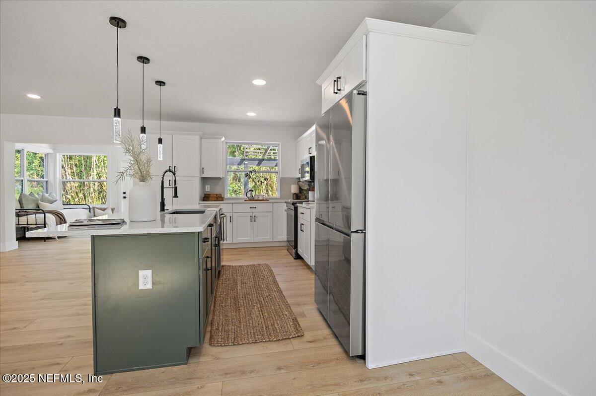 1435 Flanders Road Jacksonville, FL 32207 - Photo 7 of 21 a kitchen with stainless steel appliances granite countertop a refrigerator and a sink
