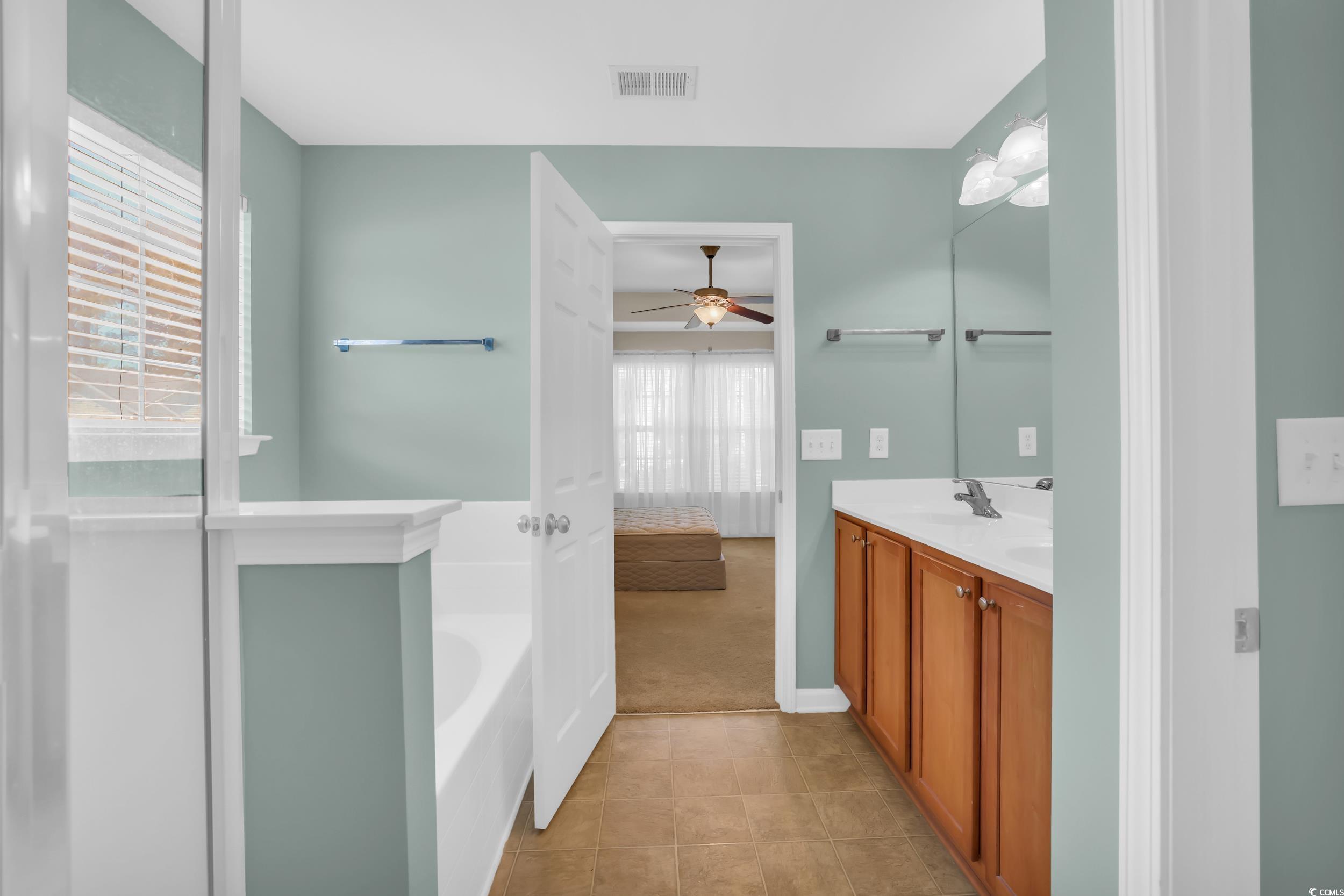 244 Devonbrook Place Longs, SC 29568 - Photo 23 of 40 Bathroom featuring a sink, visible vents, tile pat