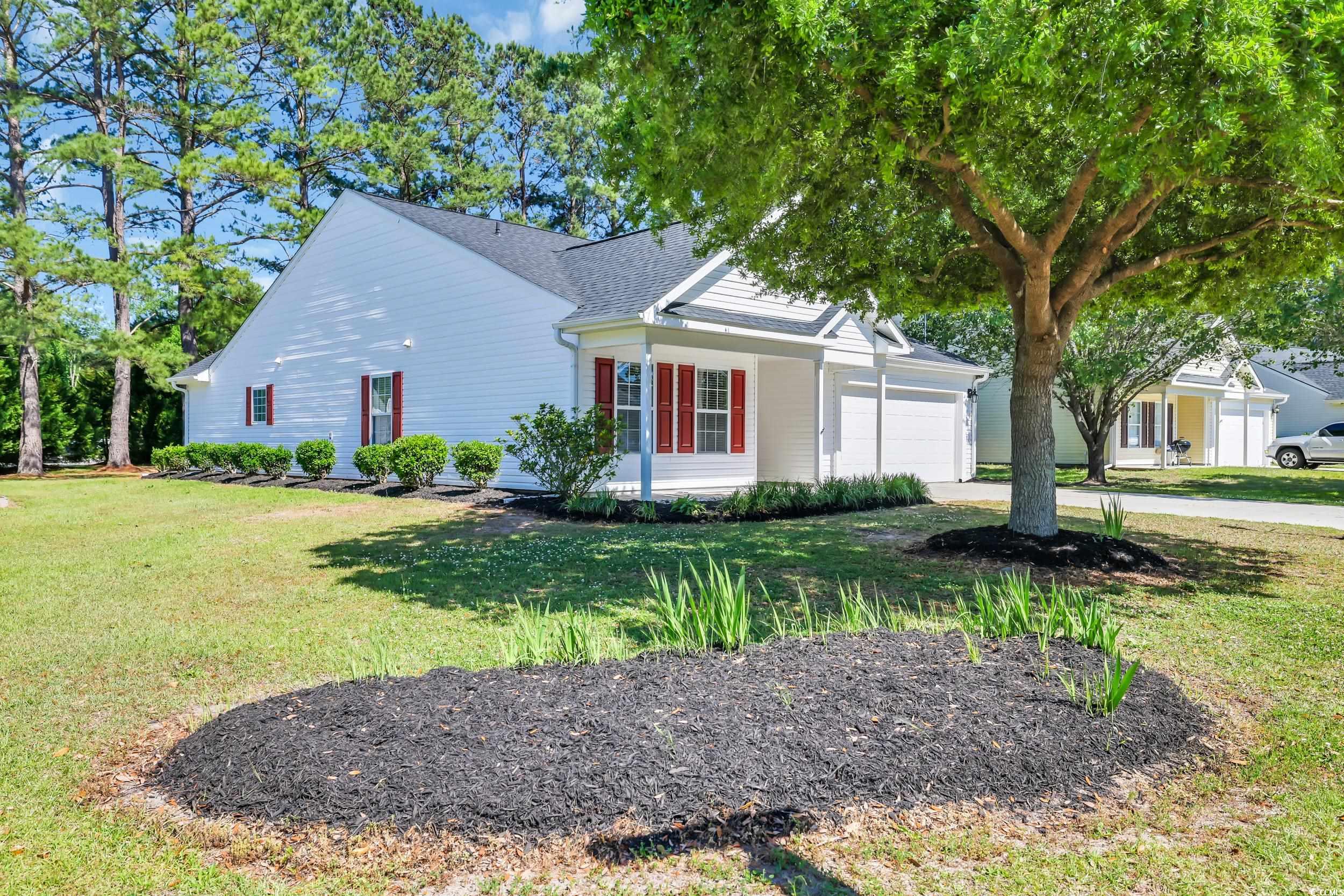 View of front facade featuring concrete driveway,