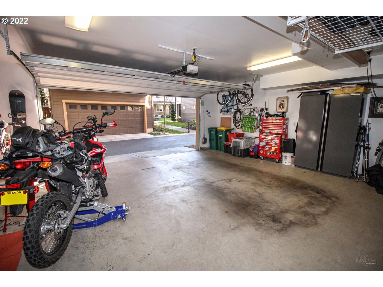 14174 Southwest Compass Drive Beaverton, OR 97005 - Photo 23 of 32 a view of a garage with a bike and car