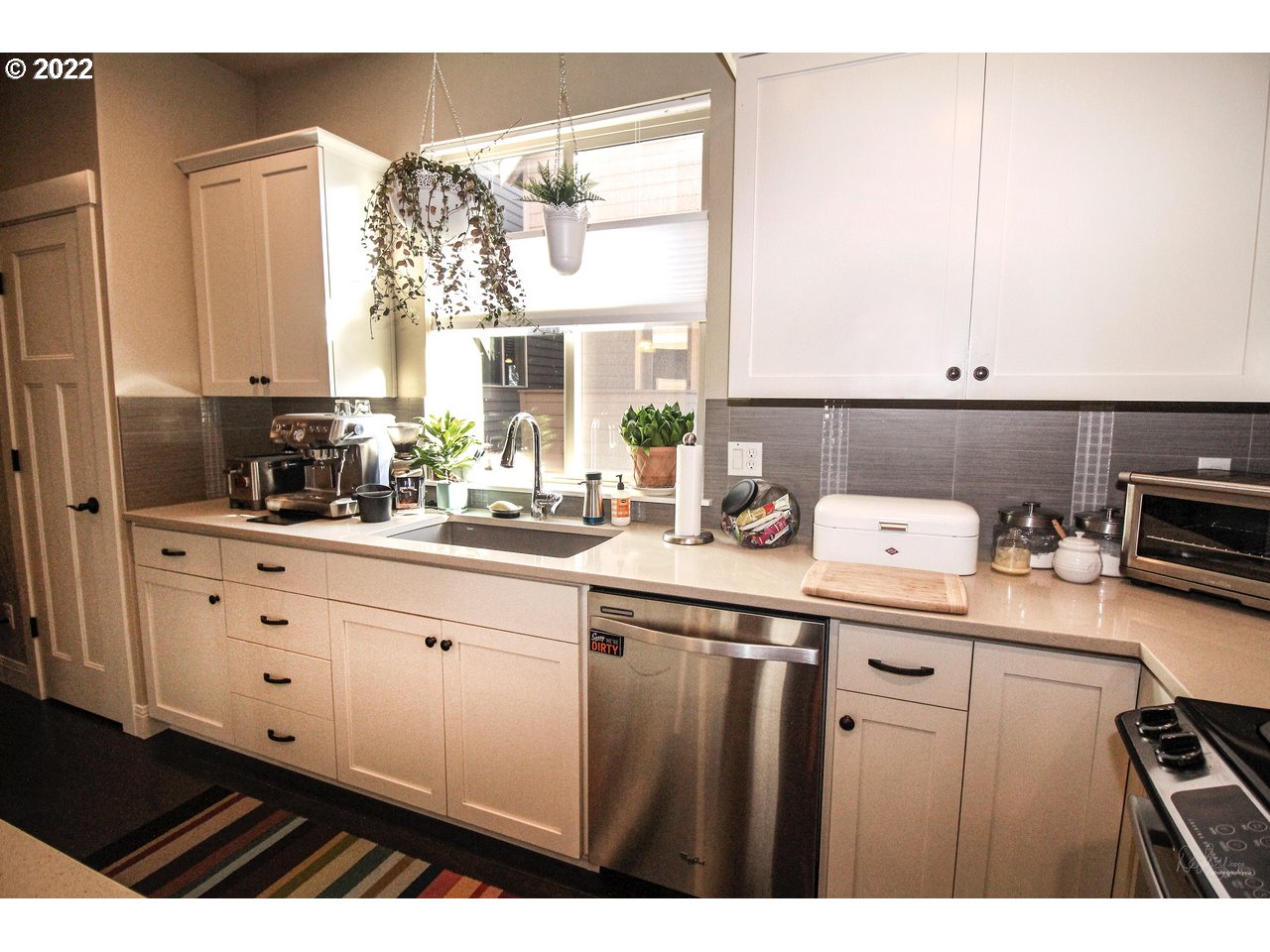 14174 Southwest Compass Drive Beaverton, OR 97005 - Photo 9 of 32 a kitchen with a sink cabinets and window