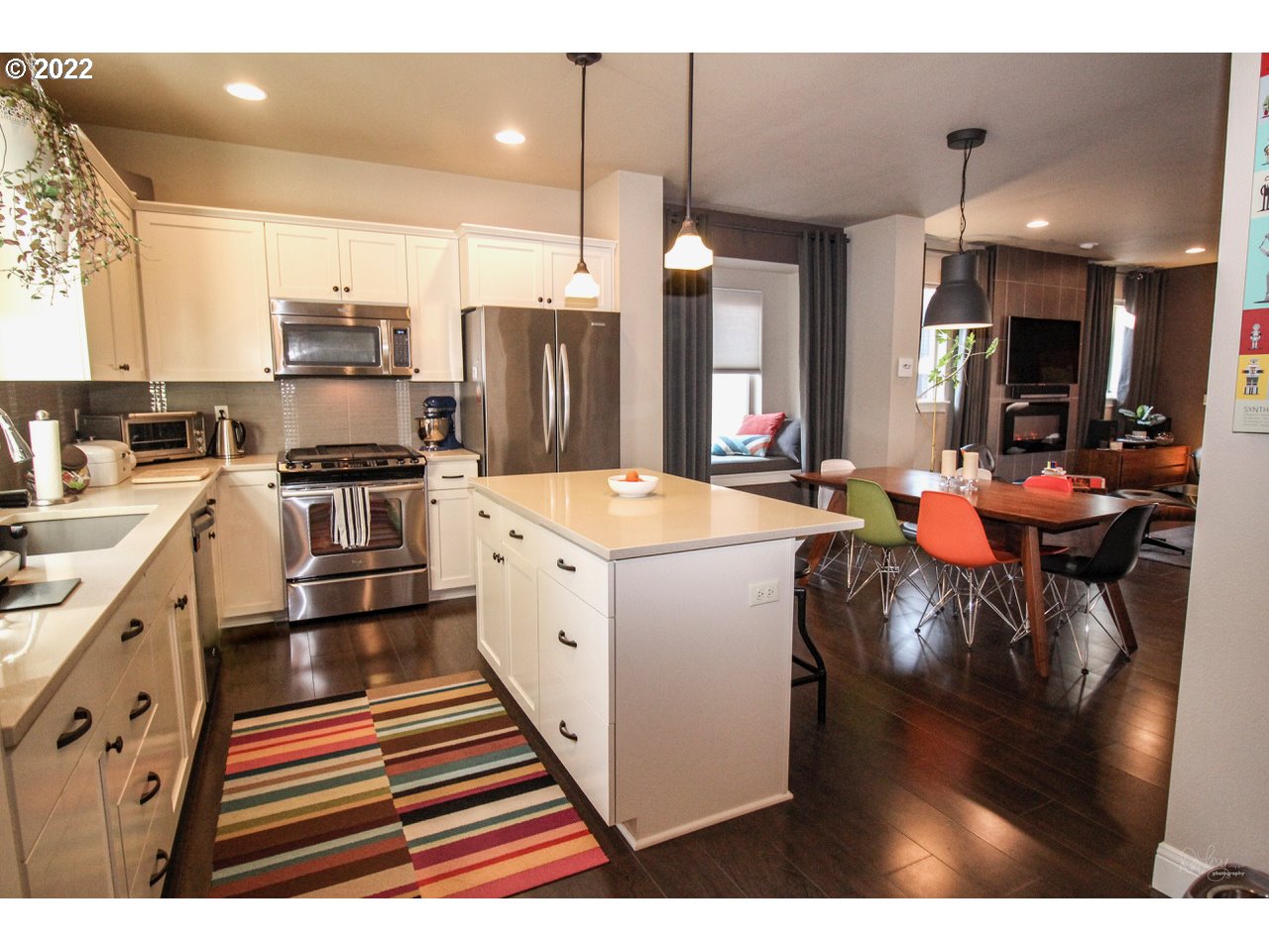 14174 Southwest Compass Drive Beaverton, OR 97005 - Photo 10 of 32 a large kitchen with stainless steel appliances kitchen island granite countertop a sink and cabinets