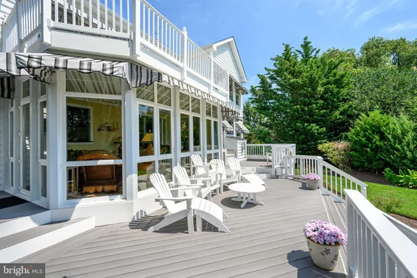 a view of a chair and tables back yard of the house