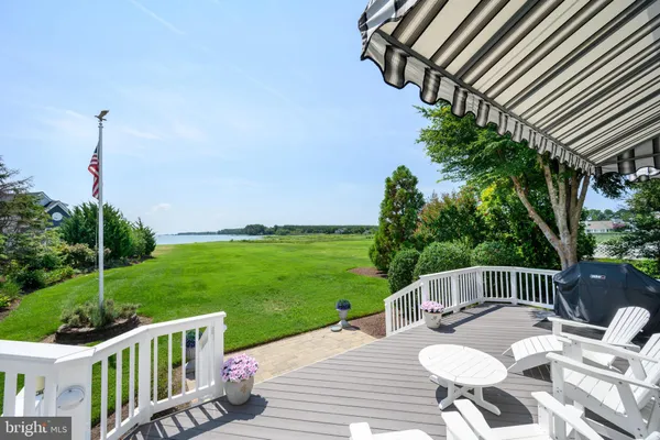 a view of a wooden deck and a backyard