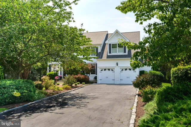 a view of a house with a small yard and tree s