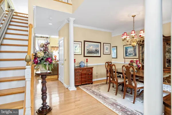 a hallway with wooden floor and dining area