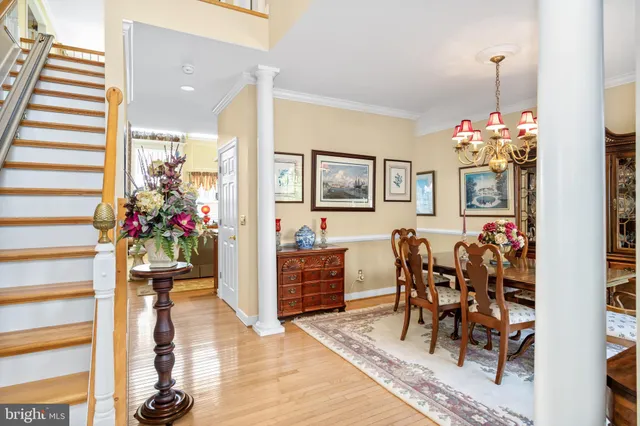 a hallway with wooden floor and dining area