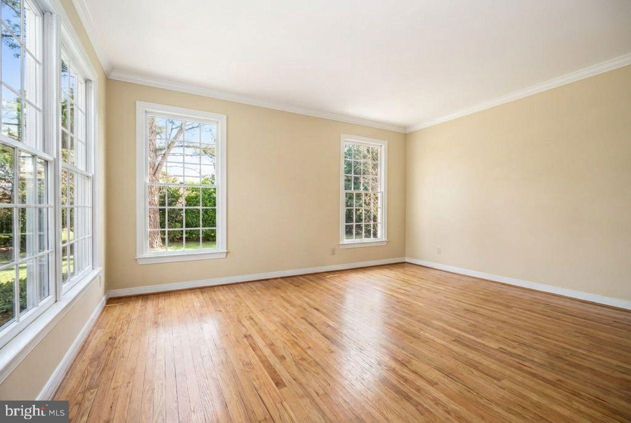 21477 Island Club Road Tilghman, MD 21671 - Photo 22 of 50 a view of an empty room with wooden floor and a window