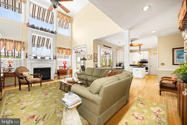 a living room with furniture a fireplace and a kitchen view