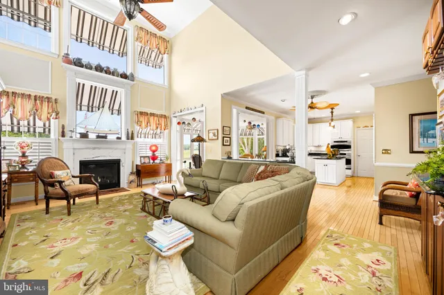 a living room with furniture a fireplace and a kitchen view
