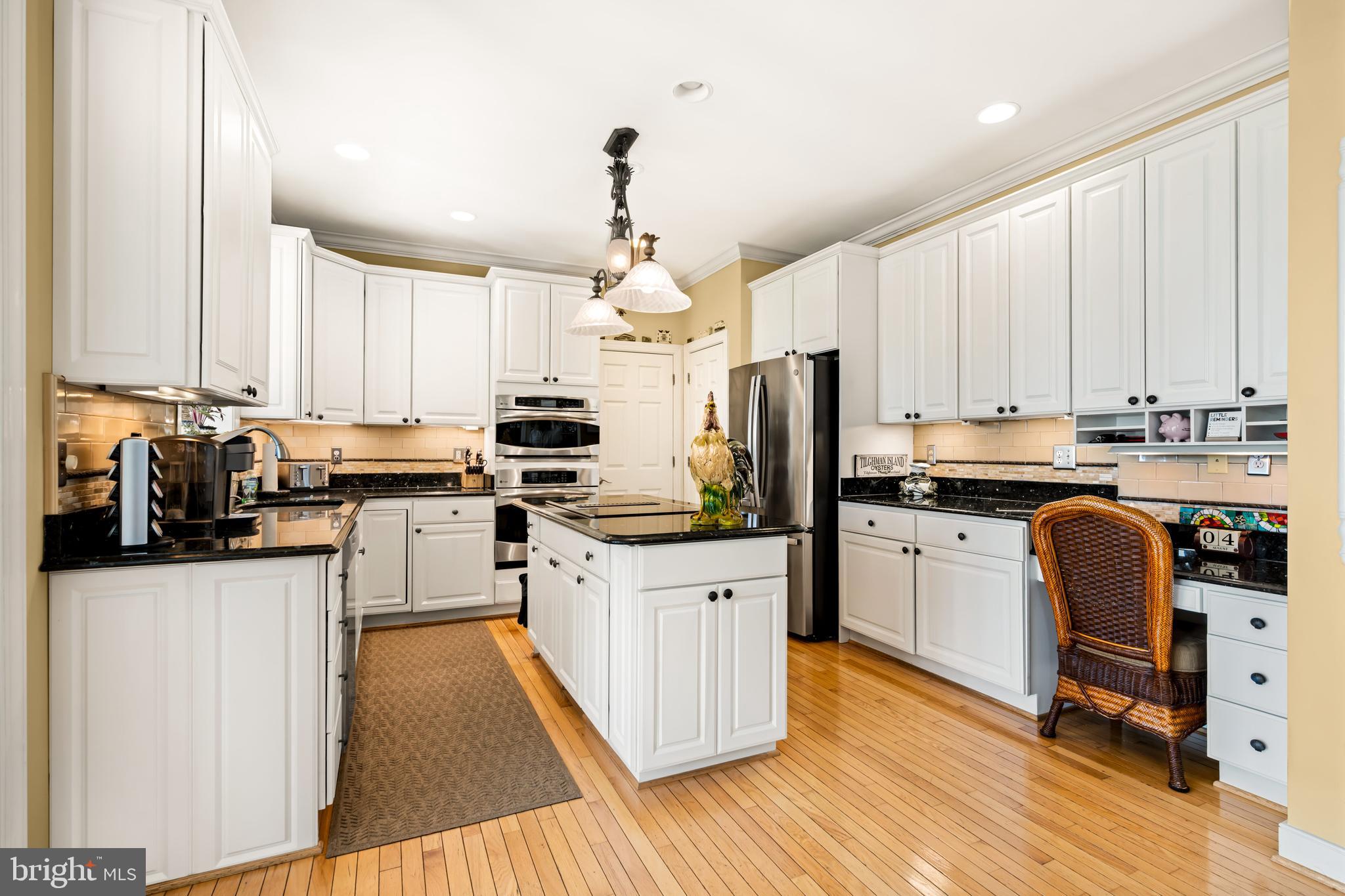 21477 Island Club Road Tilghman, MD 21671 - Photo 27 of 50 a kitchen with kitchen island granite countertop a sink appliances cabinets and a counter top space