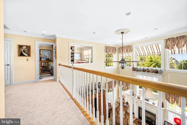 a view of a room with wooden floor windows and a chandelier