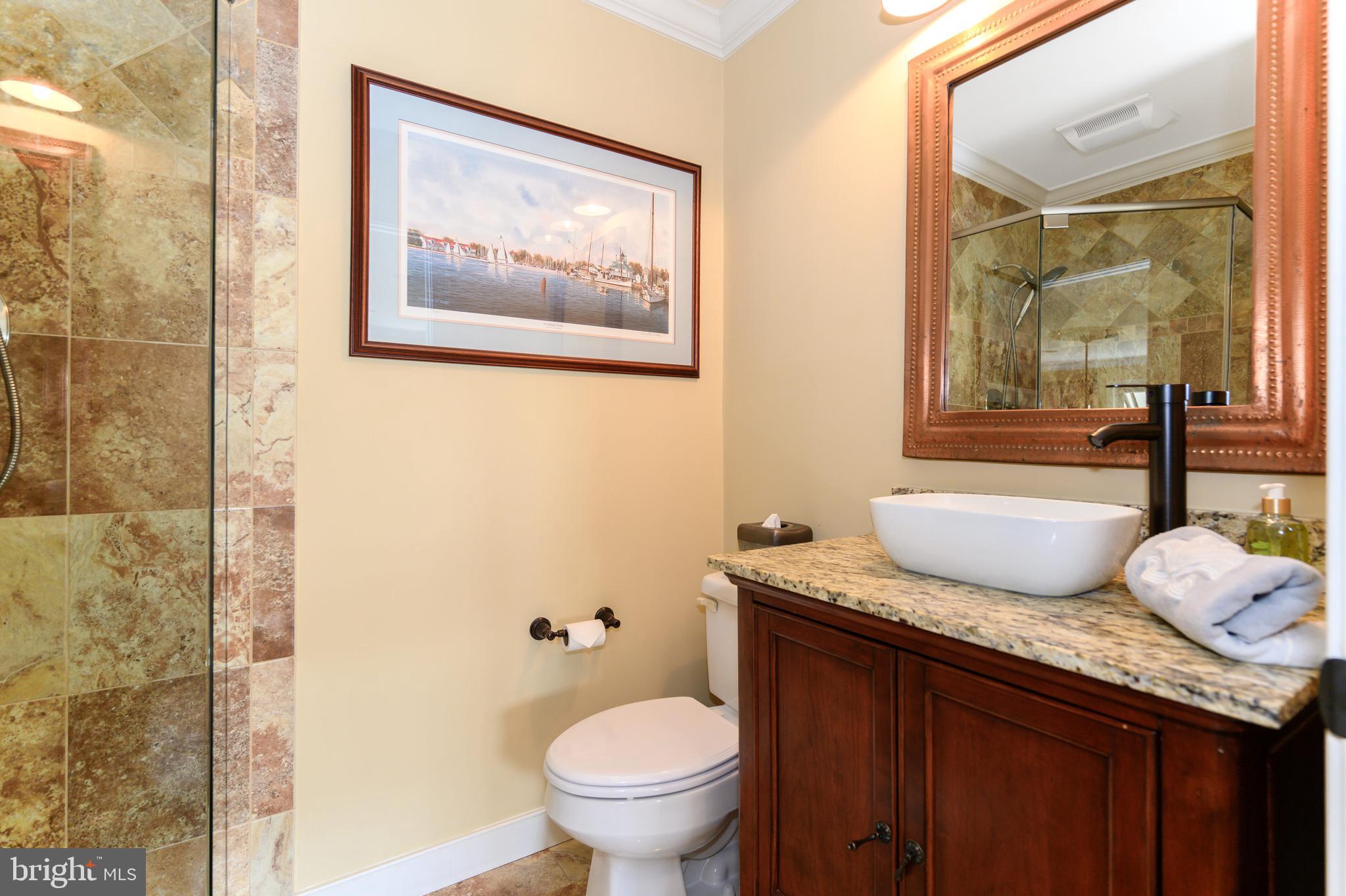 21477 Island Club Road Tilghman, MD 21671 - Photo 37 of 50 a bathroom with a granite countertop sink mirror vanity and toilet