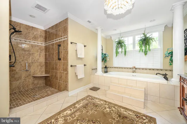 a white bath tub sitting in a bathroom next to a window