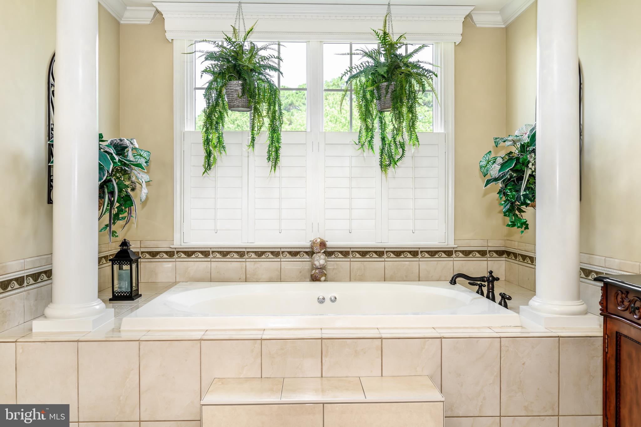 21477 Island Club Road Tilghman, MD 21671 - Photo 43 of 50 a white bath tub sitting in a bathroom next to a window