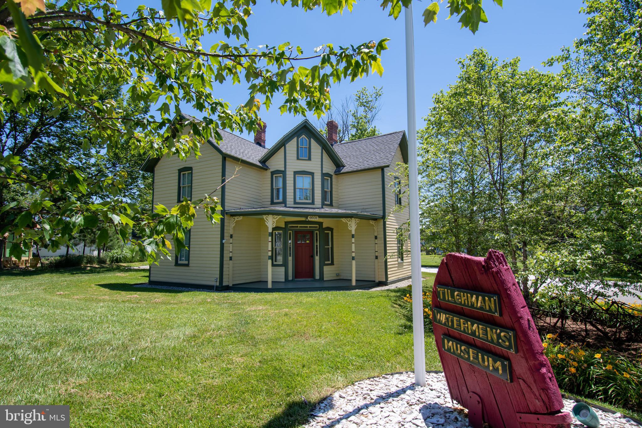 21477 Island Club Road Tilghman, MD 21671 - Photo 48 of 50 front view of a house with a yard