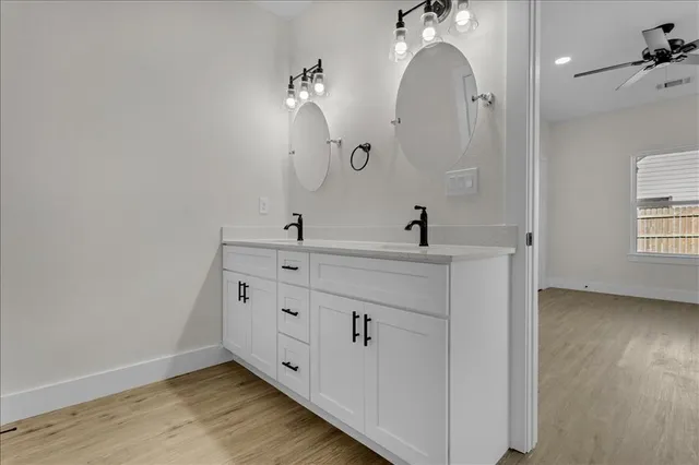 a bathroom with a double vanity sink mirror and vanity