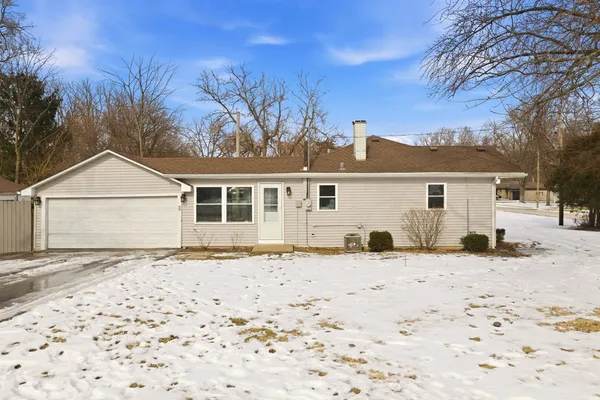 a front view of a house with a dirt yard